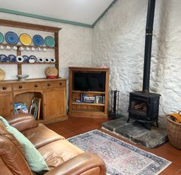 A living room with a sofa and television at Starling Cottage near Cowbridge