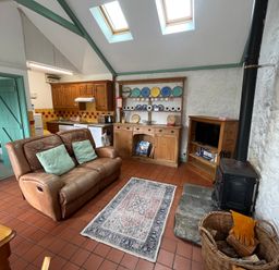 A living room with a sofa and television at Starling Cottage near Cowbridge