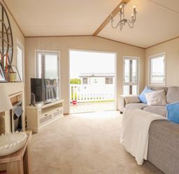 A living room with a sofa and television at CC2