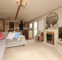 A living room with a sofa and television at CC2