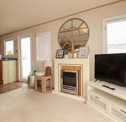 A living room with a television and fireplace at CC2