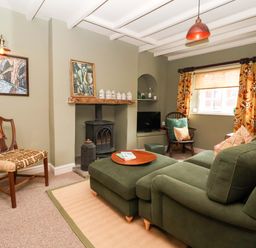A living room with a sofa and chair at The Cook’s Cottage in Malton
