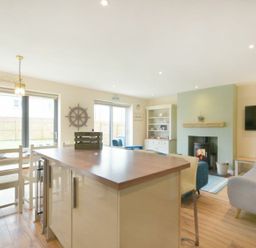 A living room with a table and chairs at Beach Walk in Chathill