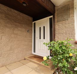 An entrance with a front door and a flowering plant at Campden in Rennington near Embleton