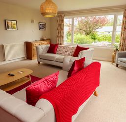 A living room with sofas and a coffee table at Campden in Rennington near Embleton