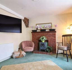 A living room with a television and fireplace at Pete's Place in Taunton
