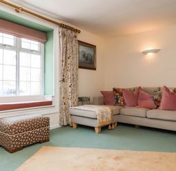 A living room with a sofa and cushions at Pete's Place in Taunton