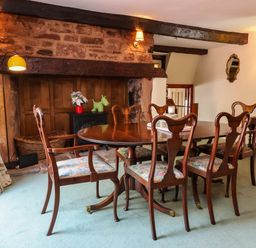 A dining room with a table and chairs at Pete's Place in Taunton