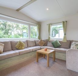 A living room with a sofa and table at Forest Retreat - FO26 Saxmundham