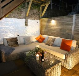 A seating area with a sofa and table in an outdoor space at Dart Views in Dartmouth