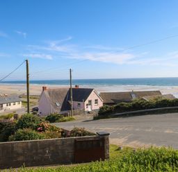 A view of houses and beach at Newgale Cottage in Newgale