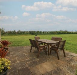 An outdoor dining area with a table and chairs at The Gallops in Barry