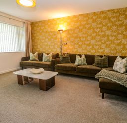 A living room with a couch and coffee table at Agan Paradhis in Quintrell Downs