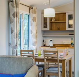 A dining room with a table and chairs at Bingos Cabin in Holt