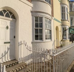 A front entrance with a white door and windows at Number 3 by the Sea in Weymouth