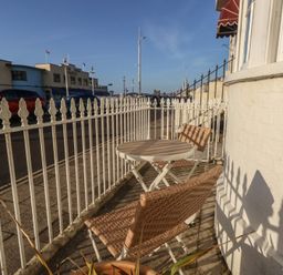 An outdoor seating area with a table and chairs at Number 3 by the Sea in Weymouth