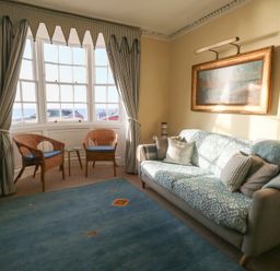 A living room with a sofa and armchairs at Number 3 by the Sea in Weymouth