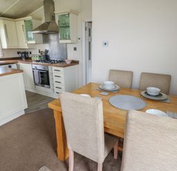 A kitchen with a dining table and chairs at Plot 34 near Armathwaite