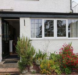 An entrance with a door and plants in front at The Headmasters Quarters in Chudleigh