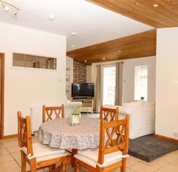 A dining room with a table and chairs at The Headmasters Quarters in Chudleigh