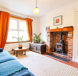 A living room with a sofa and fireplace at Hafanedd in Betws-y-Coed