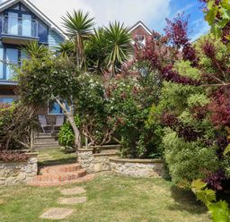 A house with a garden and pathway at Little Gem in Weymouth