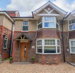 A house exterior with a front door and windows at Little Gem in Weymouth