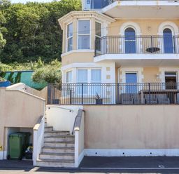 A house with a balcony and stairs at Sea Vista in Westward Ho!