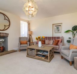 A living room with a coffee table and armchairs at Sea Vista in Westward Ho!