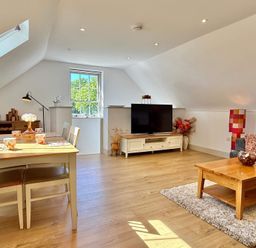 A living room with a dining table and chairs at Charming Barn Annex with Stables New Forest Escape