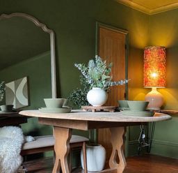 A dining room with a round table and a mirror at Llysawelon 2-Bed Cottage, Sleeps 5, Pets Ok Llysawelon near Llansteffan