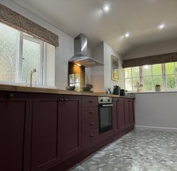 A kitchen with cabinets and a window at Llysawelon 2-Bed Cottage, Sleeps 5, Pets Ok Llysawelon near Llansteffan