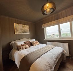 A bedroom with a bed and a window at Llysawelon 2-Bed Cottage, Sleeps 5, Pets Ok Llysawelon near Llansteffan