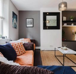 A living room with a sofa and coffee table at Licatas Apartment Cirencester Cotswolds Sleeps 6