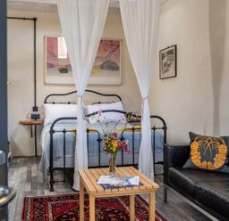 A bedroom with a bed and seating area at Little Linney Sleeps 2 Garden Parking Wifi Hartland