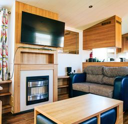 A living room with a television and sofa at Captivating 6-Person Caravan in Rhyl