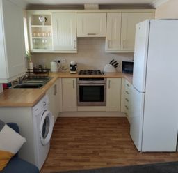 A kitchen with appliances and cabinets at Ground Floor Cornish Retreat Free Parking, Bodmin