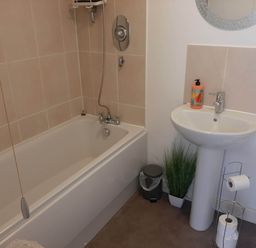 A bathroom with a bathtub and sink at Ground Floor Cornish Retreat Free Parking in Bodmin