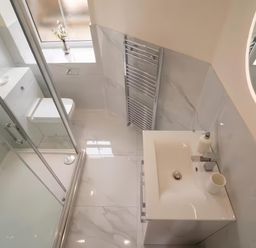 A bathroom with a sink and toilet at Foundry Farm Apartment