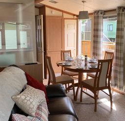 A dining area with a table and chairs at Static Caravan 2 Bedrooms - sleeps 4 in Hawick