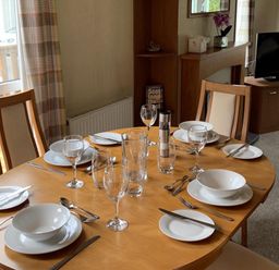 A dining room with a table set for meals at Static Caravan 2 Bedrooms - sleeps 4, Hawick
