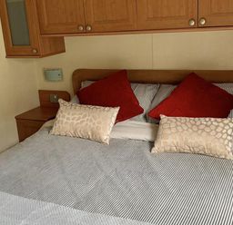 A bedroom with a bed and pillows at Static Caravan 2 Bedrooms - sleeps 4 in Hawick