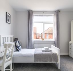 A bedroom with a bed and a desk at Lily Apartment - Sleeps 3 - Pet friendly - Parking in Bedlington