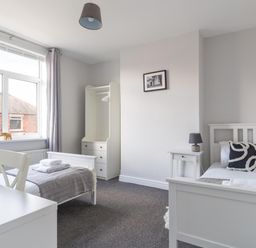 A bedroom with two beds and a wardrobe at Lily Apartment - Sleeps 3 - Pet friendly - Parking in Bedlington