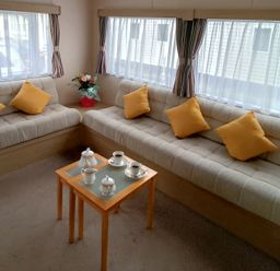 A living room with a table and sofa at 3 Bed, Sleeps 6, Parking