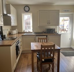 A kitchen with a table and chairs at TBC in 