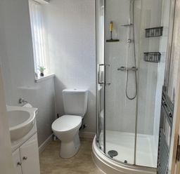 A bathroom with a shower toilet and sink at TBC in 