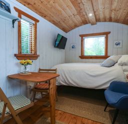 A bedroom with a bed and a table at Ardwyn in Pwllheli