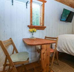 A bedroom with a table and chairs at Ardwyn in Pwllheli