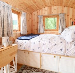 A bedroom with a bed and windows at Laurel near Littleport